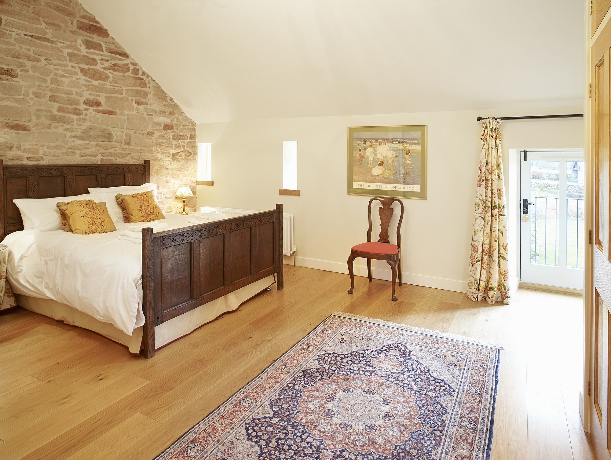 Riverain Coach House Ullswater bedroom on first floor with cast iron bath and shower over luxury self catering holiday cottage near Lake District National Park at The Rowley Estates