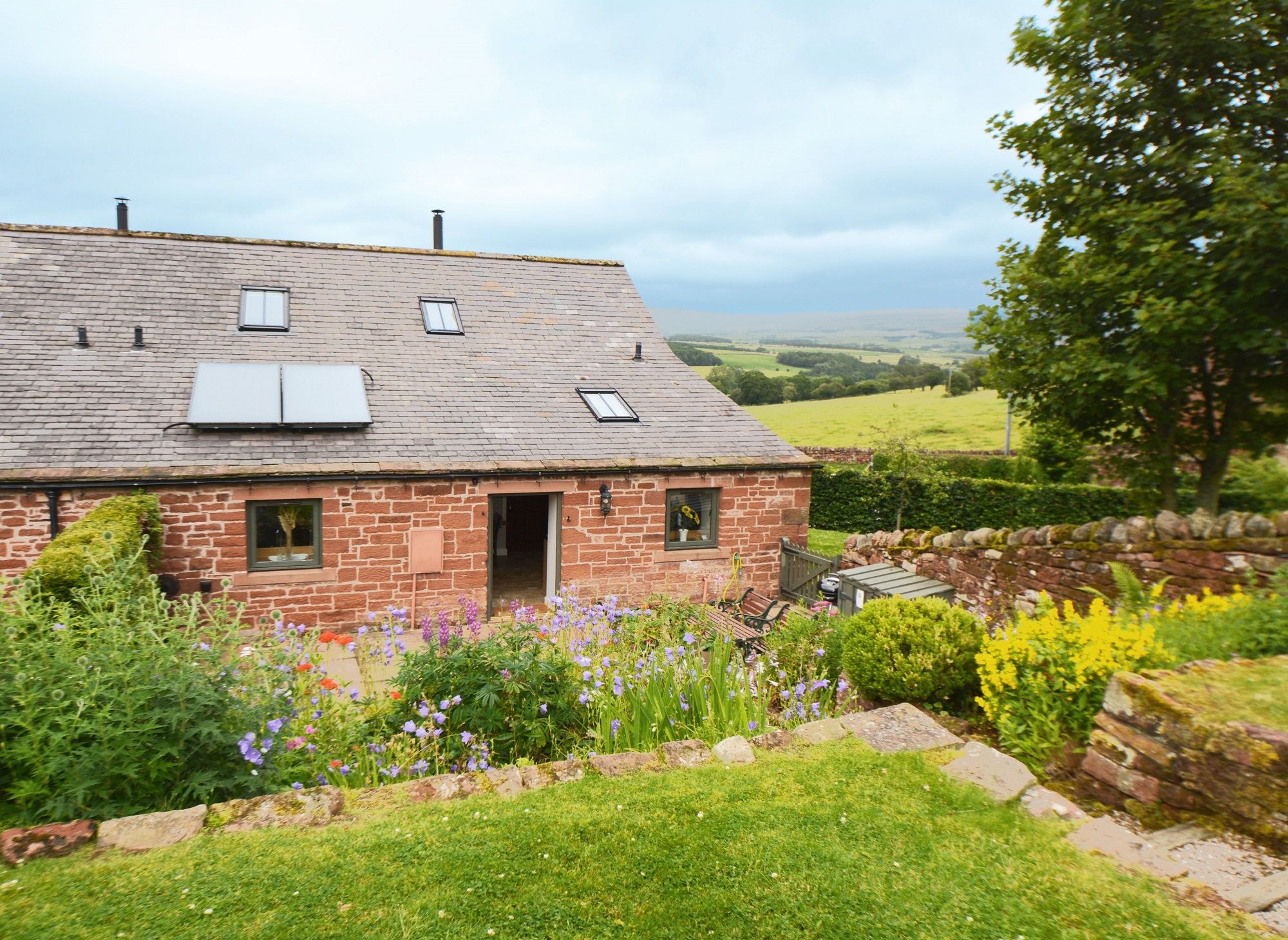 Jenny's Croft holiday cottage rear sandstone terrace courtyard garden dog friendly holiday cottage at The Rowley Estates