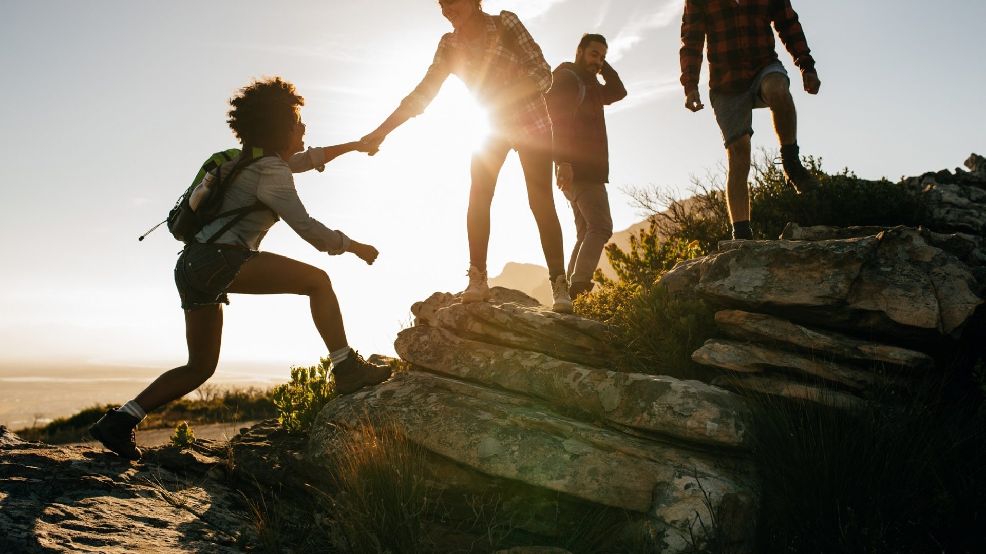 Young People On Mountain Hike At Sunset