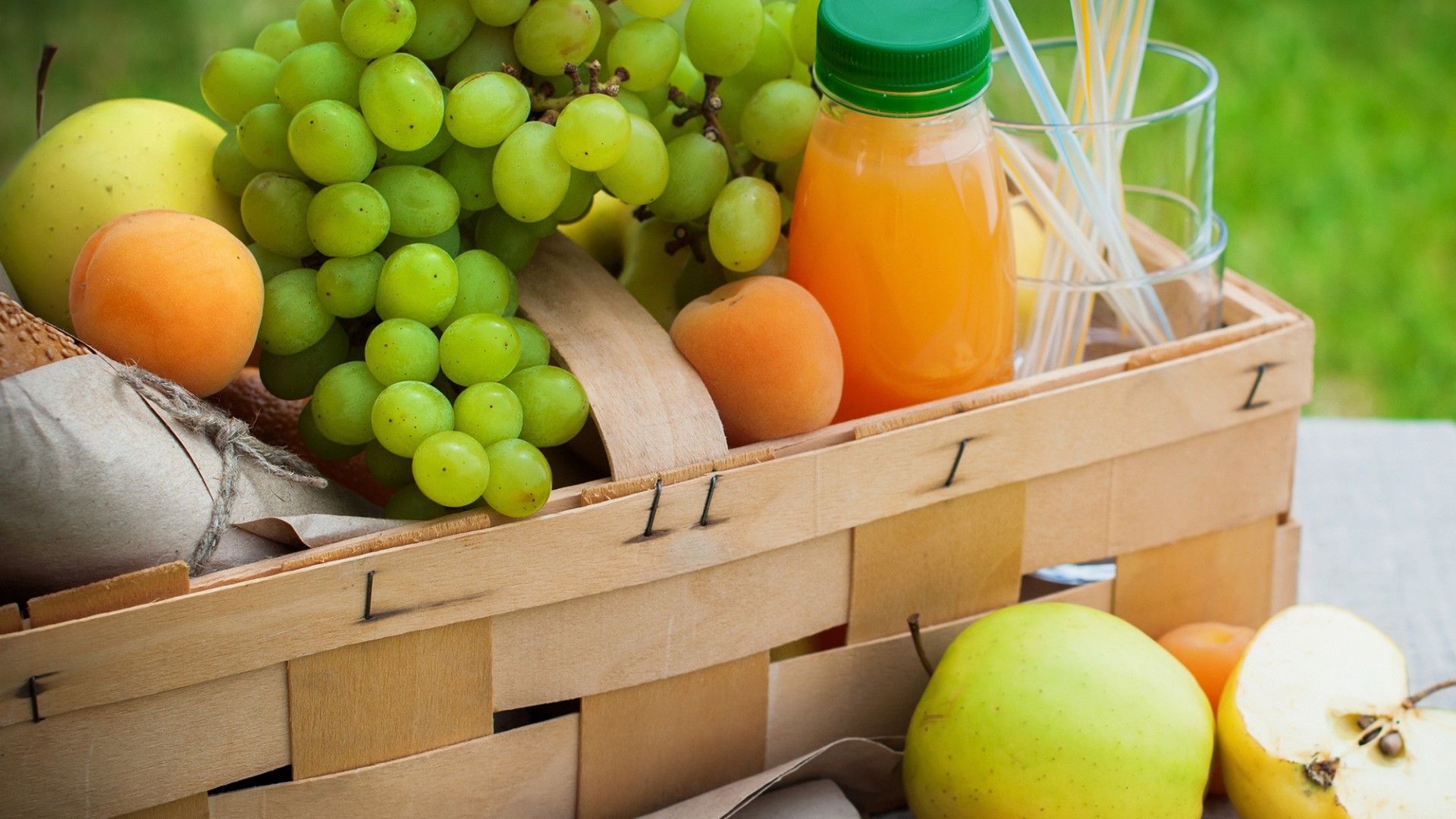 Picnic Basket Yellow Orange Green Fruits on Grass Background Summer Time Selective focus