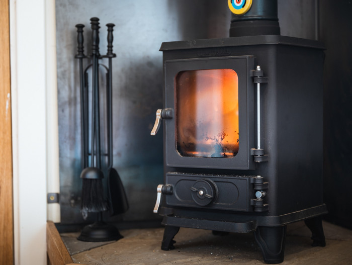 cast iron log burning stove in elm retreat shepherds hut at the rowley estates