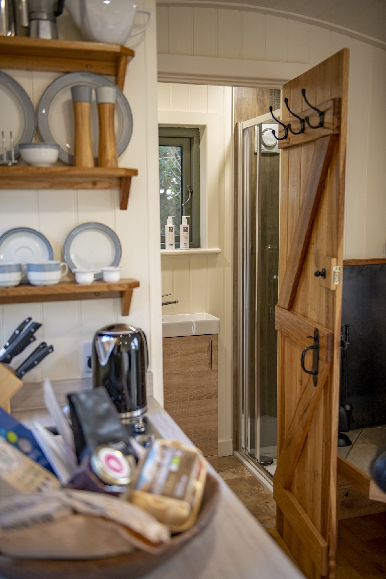 kitchen and door leading to ensuite shower room in elm retreat shepherds hut